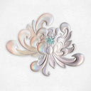 Detail of embossed abstract semi holographic chrysanthemum with a small peek of a face coming out of the center. Embossment is at bottom center of the print.