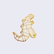 Enamel pin of an origami kaiju monster, standing and facing the right with spikes on its back and a large tail. Gold outlining.
