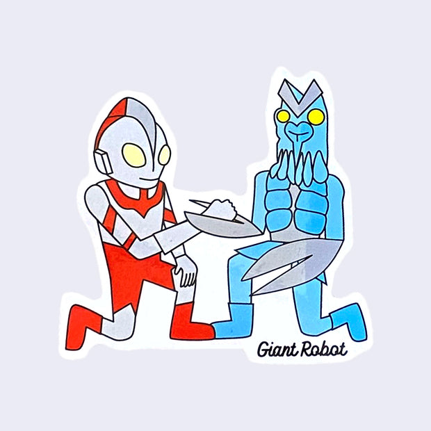White cut out sticker of a Japanese silver sentai with red accents kneeling and locking a hand with a blue aquatic kaiju, who is also kneeling.