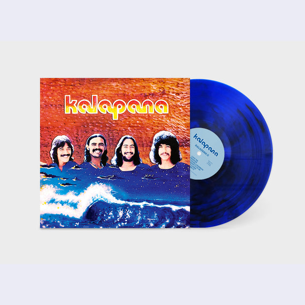 Dark blue Kalapana record coming out of an orange and blue record sleeve. Four men's heads emerge from an illustration of a blue sky and blue crashing waves. "Kalapana" is written in stylized font in the top center.