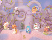 8 differently designed forest themed cherub children figures, situated in a whimsical purple forest setting. Designs include: moth theme, daisy theme, pine tree theme, cat theme, ocean theme, statue, mushroom theme and frog companion.