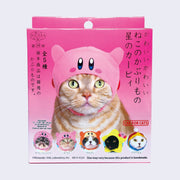 Pink blind box packaging, a orange and white striped cat wears a snug cap with a Kirby design. Below are 5 other options, detailed in next photo. Japanese script is on the box.