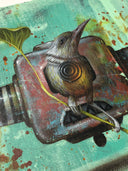 Painting on stylistically messy green background of a square shaped robot head, with 2 horns coming out the side.It has a pointed teeth frown, and a brown and green bird blocks the rest of its face, perched in front of it. 