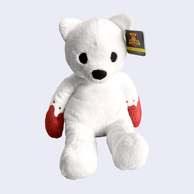 White fluffy bear plush, with a simplified face that only has black eyes and a black nose. Its hands are covered in red coloring, like blood.