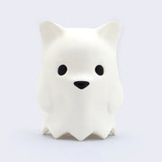 Large vinyl simplified white bear head figure, with small round black eyes and a small black triangle nose. It has points around its neck that hold it up, like the bottom of a collar.  