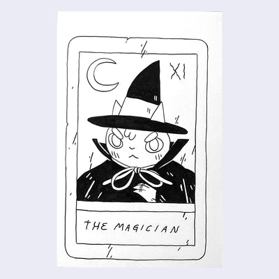Ink drawing on white paper of a mock tarot card, titled "The Magician." Card features a drawing of a cat wearing a black hat and a cloak.