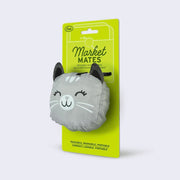 A smiling, gray and white cat attached to a green hang tag by a clip. "Market Mates" is written on the tag.