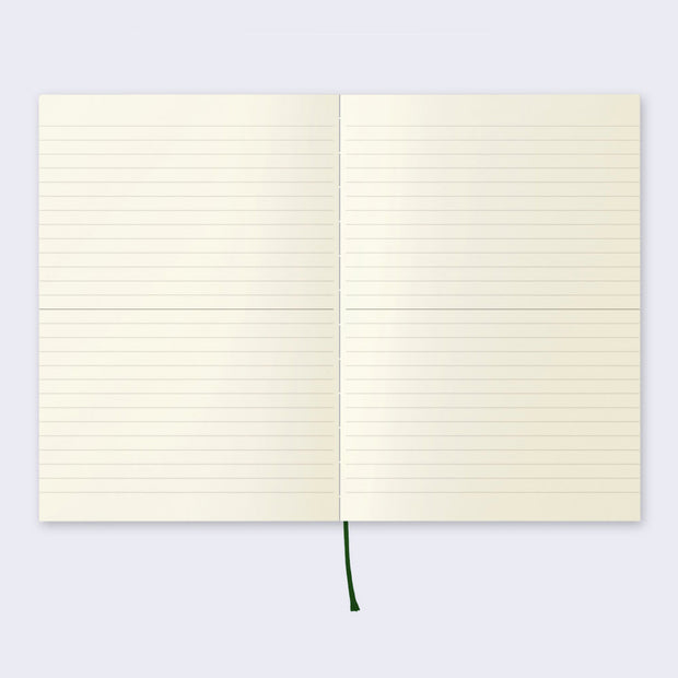 Open page spread of the notebook displaying lined cream colored paper and a black ribbon for place marking.