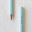 Sharpened blue color pencil and the bottom of another pencil, with "MD Paper Products" written in all caps on the side.