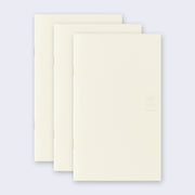 3 cream colored blank notebooks, stacked up on one another.