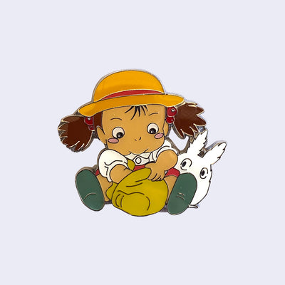 Mei sitting and searching through a tan pouch in her lap, while white Chibi Totoro looks over her shoulder.