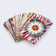 Stack of splayed out postcard with art and designs by James Jean. Top postcard displays a psychedelic inspired pattern with sharp lines leading to a butterfly in the center.