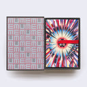 Hardcover box of postcards, open to reveal a grid style pattern within the box of "memu" written over and over. A red thread acts as a way to pull out the postcards.