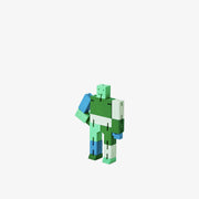 Wooden robot made of square-like shapes, standing with an arm on its hip. It is various shades of green and some blue.