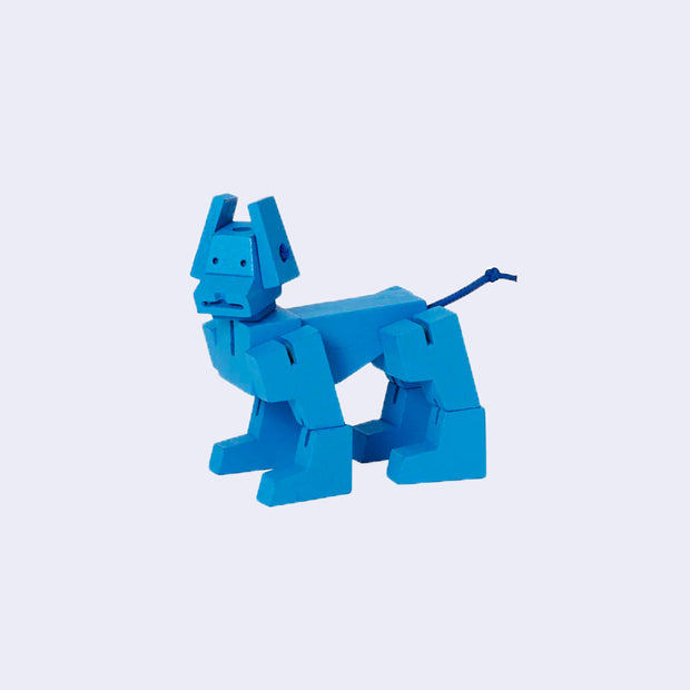 Blue wooden dog, made up of many geometric shapes with elastic strings to make it poseable.