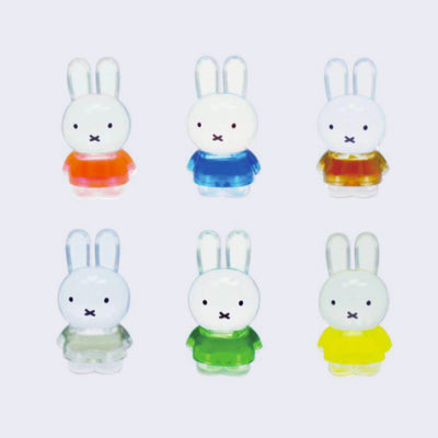 6 standing clear acrylic Miffy figures, with semi transparent shirts. Colors of shirts vary from orange, blue, brown, sage green, forest green, and yellow.