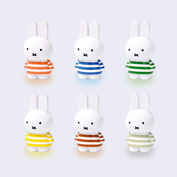 6 small plastic Miffy figures standing and each wearing a different striped shirt. Shirt colors include: orange, blue, forest green, yellow, brown and sage green.