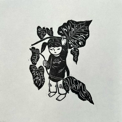 Black linocut print on paper of a small girl with pigtails and a large shirt with the design of a turtle on it. She looks through large Monstera style leaves. 