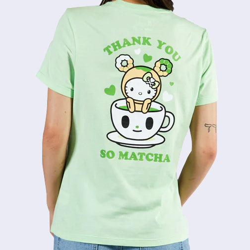 Back-side view of person wearing pastel green t-shirt. Green text says thank you so matcha. Large image of hello kitty wearing a donut hat sits inside a cup of matcha tea.