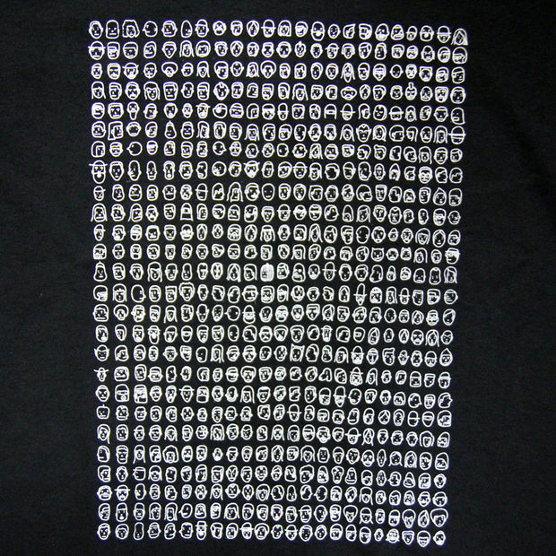Close up of tiny doodles of faces lined up in a grid like pattern on a black t-shirt.