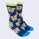 Side view of a model's feet wearing chubby cartoon boba socks. The heel area and trim are acid green. The toe area is bright blue.