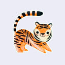 Die cut sticker of a illustration style tiger, stretching out its front paws with its long tail curving overhead.