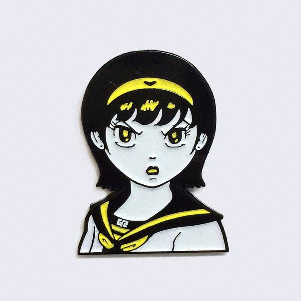 Enamel pin of an illustrated manga girl bust with an angry expression and yellow headband. "GR" is written on her collar.