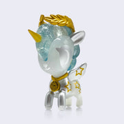Vinyl unicorn figure, half silver and half semi translucent with gold necklace, horn, star pattern on its side and wings, and leaf crown on its head.
