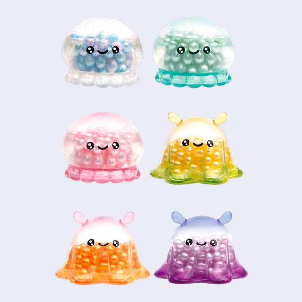 6 small sea creature design figures, see through with beads inside of them, all with different color schemes. There are 3 flapjack octopi and 3 jellyfish.