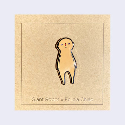 Enamel pin of a light tan, semi anthropomorphic character standing with its arms at its side and looking straight on.