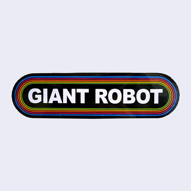 Long rounded corner rectangle sticker, black with the words "Giant Robot" written in bold, all caps white font in the center. It is surrounded by 6 thin lined borders, each a different color of the rainbow.