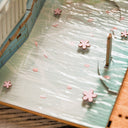 Close up of finished model kit, with reflective water and cherry blossoms floating in it.