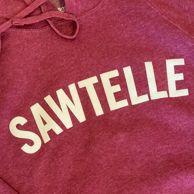 Close up of white text printed across the chest area of red heather hooded sweatshirt.