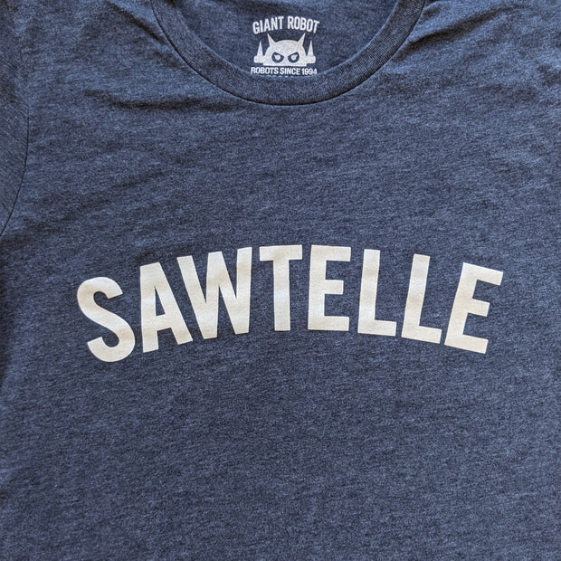 Close up of text that says sawtelle. Font is bold and reminiscent of collegiate style t-shirts.