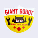 Yellow shield shaped sticker, with white top. "Giant Robot" is written in red bold font along top. A Big Boss Robot head is above "Robots Since 1994" with arms coming out of the text. 3 red sparkles are on the bottom.