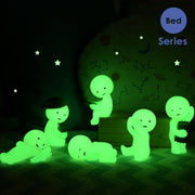 6 glow in the dark versions of Smiski Bed series figures.