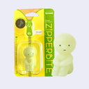 Smiski sitting on the ground and hugging their knees.