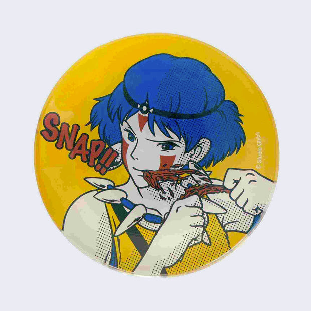 Round yellow glass plate with a image of Princess Mononoke, biting into a piece of meat and tearing it off with her mouth. "Snap!!" is written in red bubble font next to her.