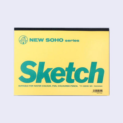 Yellow flat, horizontal sketchpad that is glue bound at the top. The cover reads "New Soho series Sketch" and in small writing below, "suitable for water colour, pen, coloured pencil"
