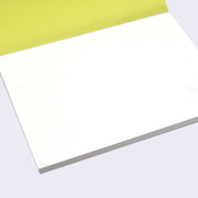 Open view of the sketch pad with the cover page flipped up, revealing a stack of bound blank white paper.