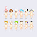 12 vinyl Kewpie babies, standing nude with different animal themed hood hats. Options are: rabbit, monkey, rooster, elephant, panda, koala, tiger, Dalmatian, frog, sloth, owl and polar bear.