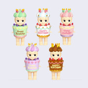 5 different Sonny Angels wearing a large decorated cake as an outfit with strawberries. It says "Happy Birthday" on it. Atop the Sonny Angel's head is a swirled hat of matching colored frosting with candles on top. Color ways include: green, white with blue, pink, purple and brown.