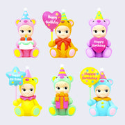 6 different designs of Kewpie babies dressed as sitting teddy bears. Colors include: pink, orange, purple, yellow, mint or blue and each is holding a different birthday object. Either a balloon, cake or present.