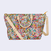 Large purse style tote bag, with beige pleather handle and sling strap. A beige "tokidoki" name plate is in the upper center. Bag is covered completely in a very busy colorful pattern of various Tokidoki characters accompanied by elements reminiscent of 70's imagery, such as rainbows, mushrooms, VW Buses and flowers.