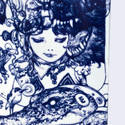 Close up of white skateboard deck with intricate blue line art illustration. Close up displays a younger girl, smirking and looking off to the side at an open growling bear's mouth. She wears a gem necklace and has an intricate helmet and headphones. Below her is an alligator with a metal collar and the letter "E" on its head.