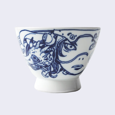 White ceramic bowl with a large rounded base that extends out slightly. A dark blue line illustration of a young girl's face, wearing a mechanical helmet and her hair intertwined with a small dragon.