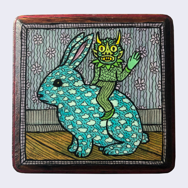 Drawing of a rabbit, blue with cloud patterns as its fur, with a small green goblin riding atop of it, waving. They seem to be inside of a home, with the background being floral wallpaper, baseboards and wood flooring. Piece is mounted on a square piece of wood with rounded edges.