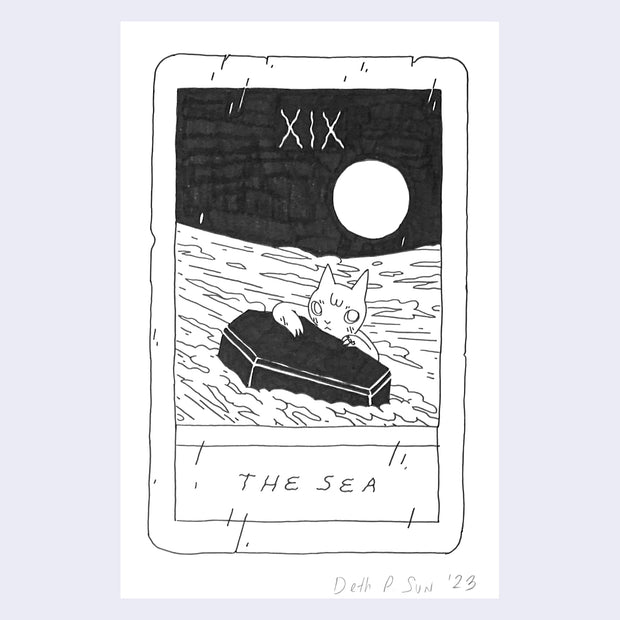 Ink drawing on white paper of a mock tarot card, titled "The Sea" and features a drawing of a cat in the sea, propped up on a coffin like a lifesaver. 
