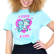 Front view of person wearing bright aqua t-shirt. On chest area is illustration of Hangyodon with a Unicorno surrounded by bright pink hearts.