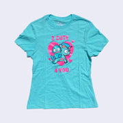 Front side of bright aqua t-shirt. Bright pink text says 2 cute 4 you. On chest area is Hangyodon and Unicorno with a large heart backdrop.